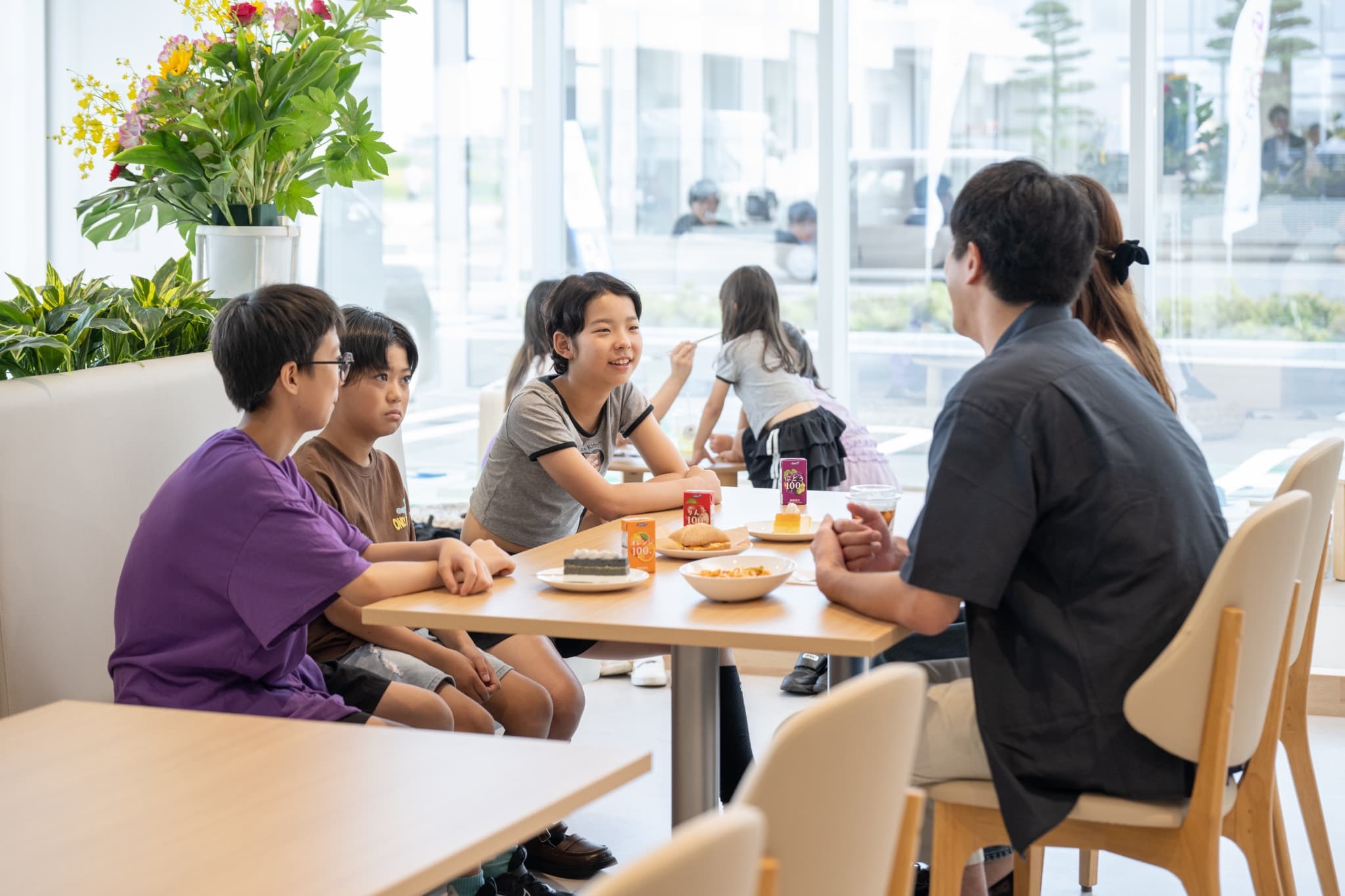 C-Cafeでテーブルを囲みくつろぐ家族の風景